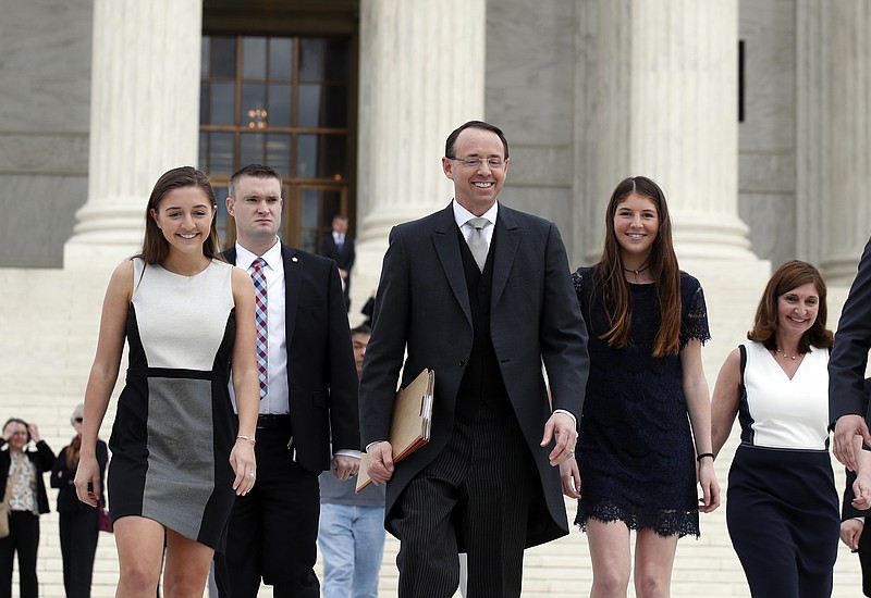 
              Deputy Attorney General Rod J. Rosenstein departs the Supreme Court on Monday, April 23, 2018, in Washington, with his family, after arguing his first case before the court. He was defending the government's position in a case involving the prison sentence for a convicted drug dealer. (AP Photo/Alex Brandon)
            