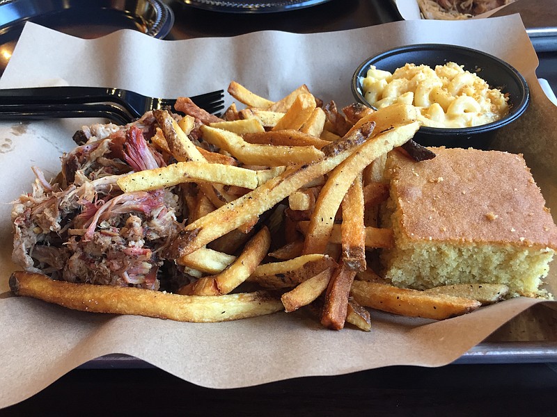 Six ounces of pulled pork go on a Mission BBQ sandwich with fries and house-made macaroni and cheese.