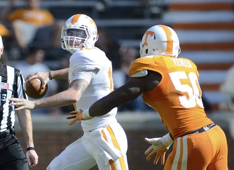 Riley Ferguson tries to evade Corey Vereen while looking for a receiver during Tennessee's Orange and White spring game in April 2014. Ferguson did not win the starting job and left the Vols that year, ending up out of football before playing a year at a community college and his final two seasons at Memphis. He hopes to be drafted by an NFL team this week.