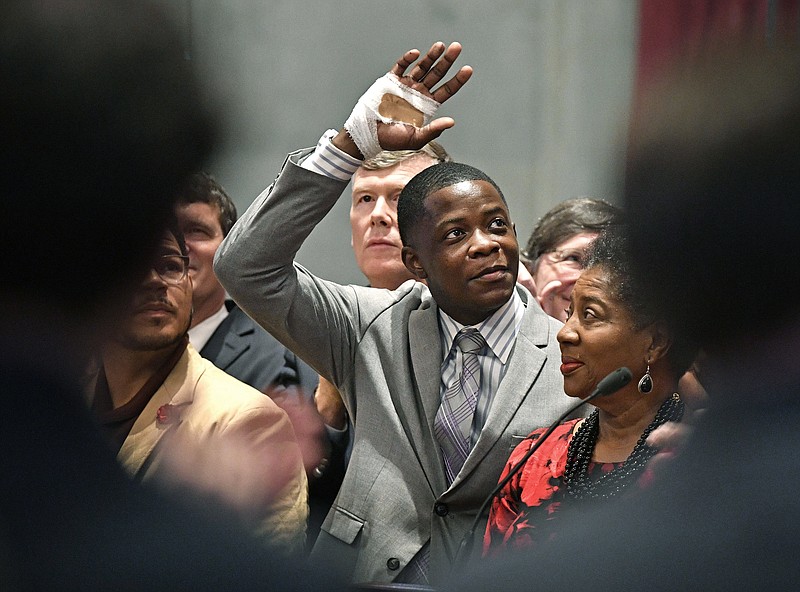 James Shaw Jr., waves to the crowd and legislators inside the Tennessee House chambers as he is honored for disarming a shooter inside a Nashville-area Waffle House at the Tennessee State House Tuesday April 24, 2018, in Nashville, Tenn. (Larry McCormack/The Tennessean via AP)

