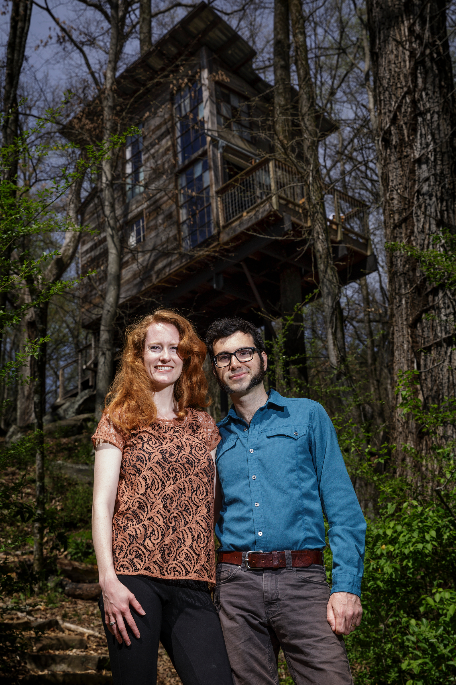 Enoch Elwell, right, and his wife Hannah pose for a portrait in front of their treehouse vacation rental on Saturday, March 31, 2018, in Flintstone, Ga.
