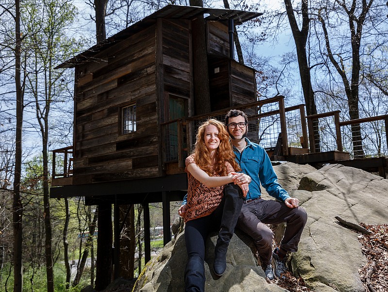 Enoch Elwell, right, and his wife Hannah pose for a portrait in front of their treehouse vacation rental on Saturday, March 31, 2018, in Flintstone, Ga. 