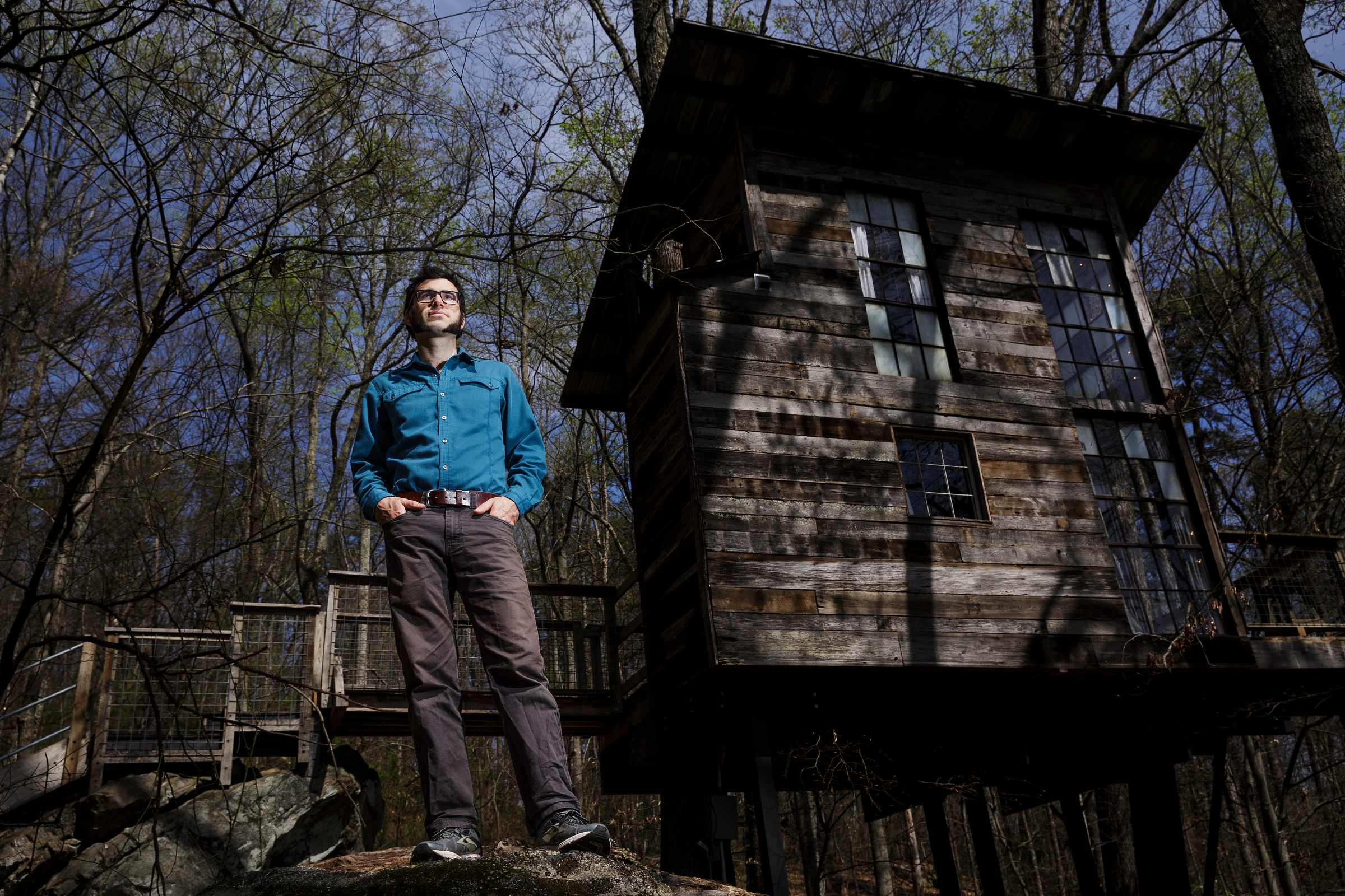 Enoch Elwell poses for a portrait in front of the treehouse vacation rental he owns with his wife Hannah on Saturday, March 31, 2018, in Flintstone, Ga.