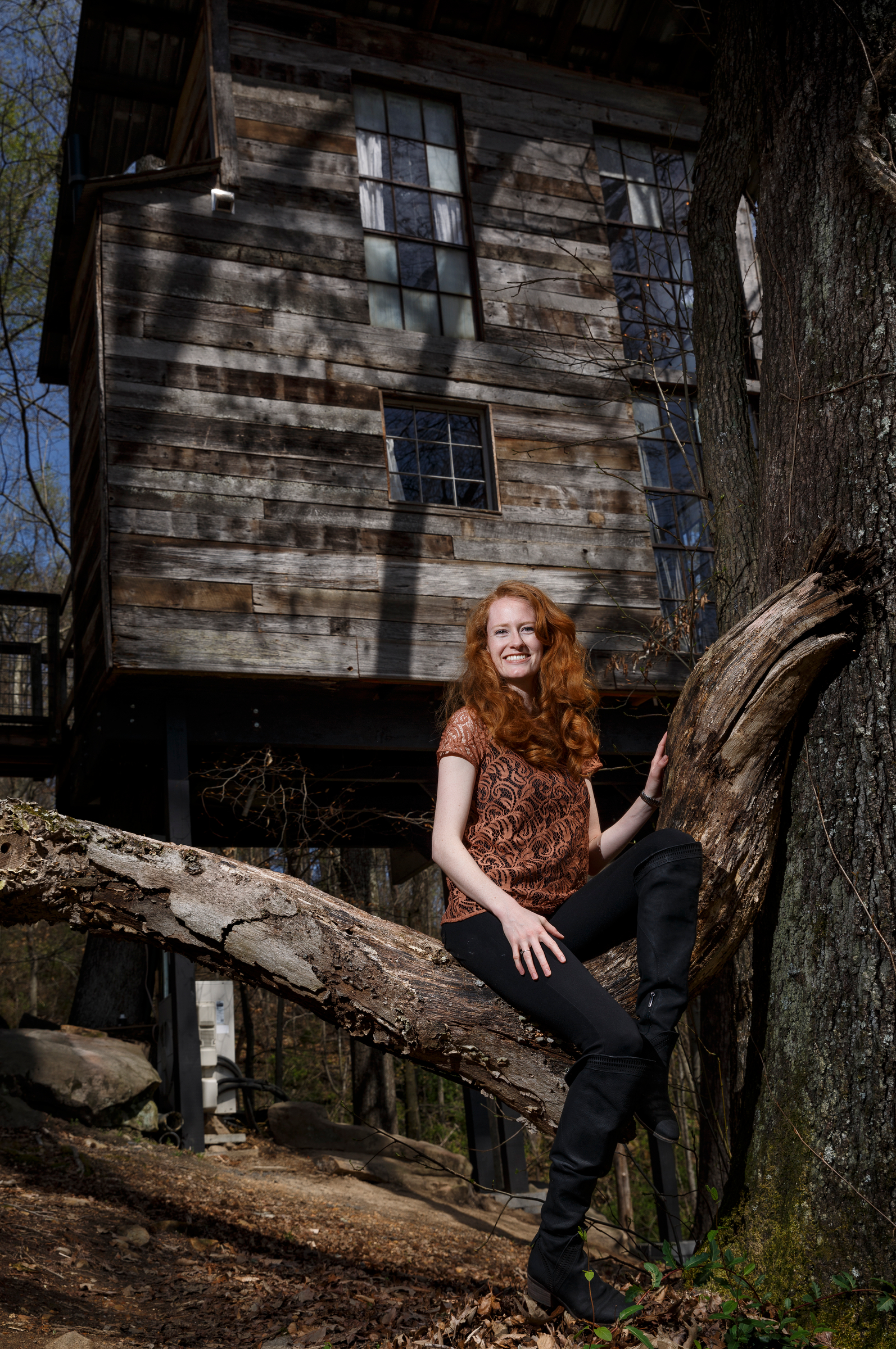 Hannah Elwell poses for a portrait in front of the treehouse vacation rental she owns with her husband Enoch on Saturday, March 31, 2018, in Flintstone, Ga.