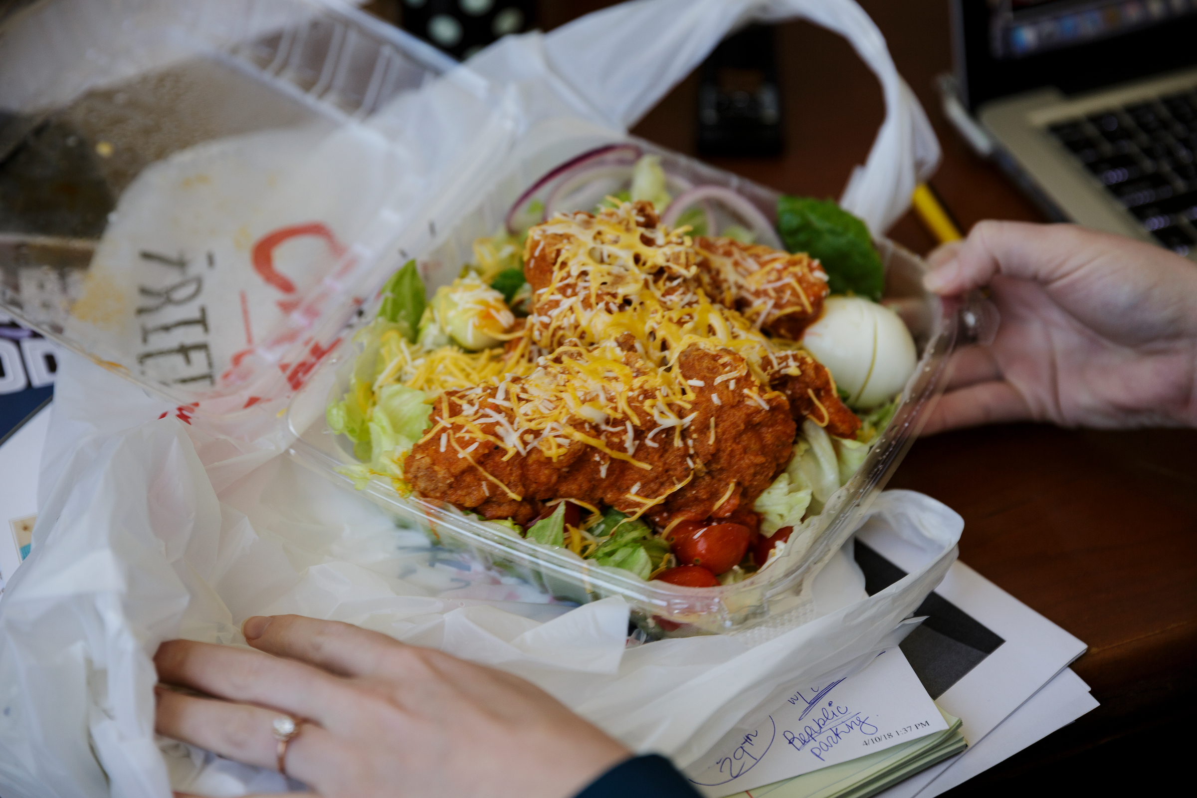 Business reporter Allison Shirk prepares to eat a salad from Champy's after ordering it through Dinner Delivered at the Times Free Press building on Friday, April 13, 2018, in Chattanooga, Tenn.