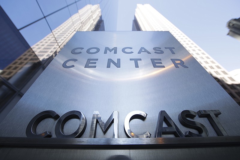 FILE- This March 29, 2017, file photo shows a sign outside the Comcast Center in Philadelphia. Comcast Corp. reports earnings Wednesday, April 25, 2018. (AP Photo/Matt Rourke, File)