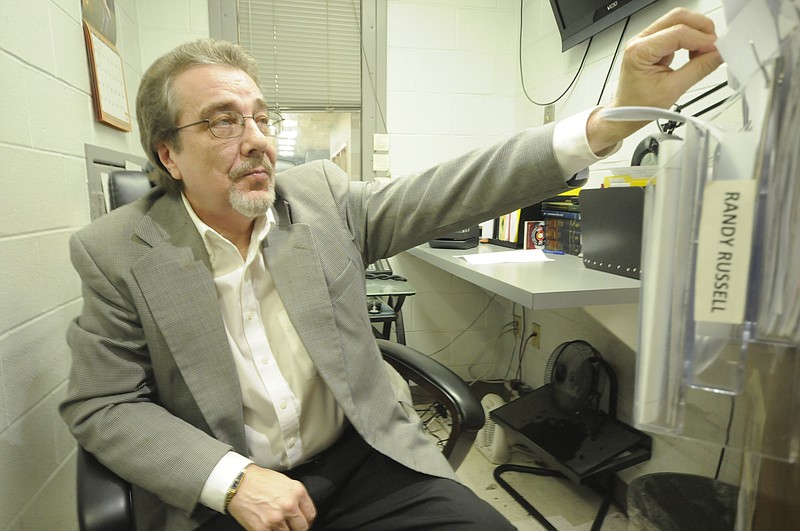 In this June 2016 staff file photo, Chief Magistrate Randy Russell pulls a file from the back of the door in his narrow office at the Hamilton County Jail. 
