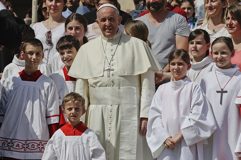 
              Pope Francis poses with clergy boys and girls during for his weekly general audience, at the Vatican, Wednesday, April 25, 2018. Pope Francis has hailed a "two Koreas" summit this week on the Korean Peninsula as an opportunity to start dialogue, and urged those involved to "have the courage" to be "artisans of peace." (AP Photo/Andrew Medichini)
            