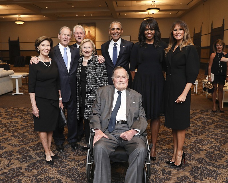 This Saturday, April 21, 2018, photo provided by the Office of former U.S. President George H.W. Bush, shows Bush, front center, and past presidents and first ladies Laura Bush, from left, George W. Bush, Bill Clinton, Hillary Clinton, Barack Obama, Michelle Obama and current first lady Melania Trump in a group photo at the funeral service for former first lady Barbara Bush, in Houston. 