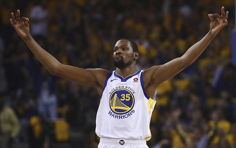 Golden State Warriors' Kevin Durant celebrates a score against the San Antonio Spurs during the first quarter in Game 5 of a first-round NBA basketball playoff series Tuesday, April 24, 2018, in Oakland, Calif. (AP Photo/Ben Margot)