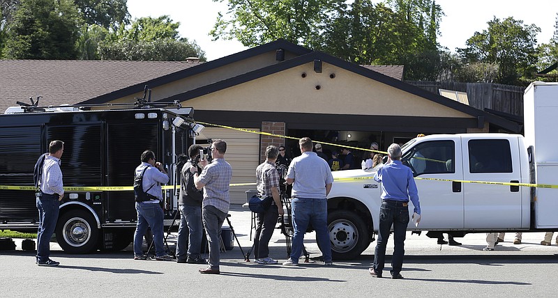 A car is backed out of the garage of a home searched in connection with the arrest of a man on suspicion of murder, April 25, 2018, in Citrus Heights, Calif. 