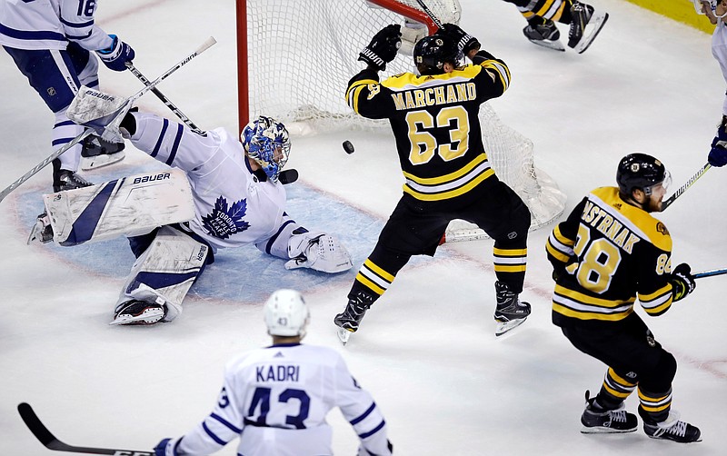 Toronto Maple Leafs goaltender Frederik Andersen looks back as the puck bounces to the back of the net on a goal by Boston Bruins right wing David Pastrnak (88) during the third period of Game 7 of an NHL hockey first-round playoff series in Boston, Wednesday, April 25, 2018. At center is Bruins left wing Brad Marchand (63). (AP Photo/Charles Krupa)