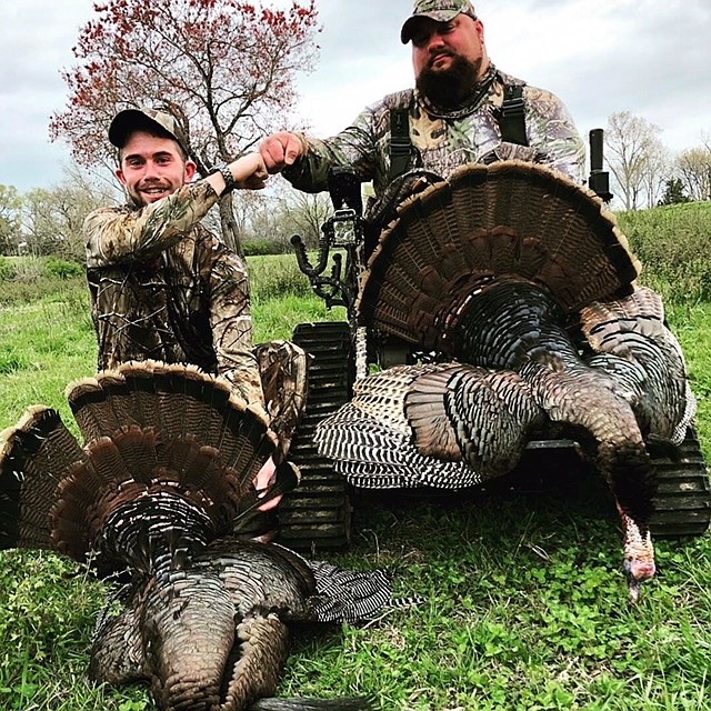 Guide Scott Wier, left, and disabled military veteran Christian Brown fist-pump behind their winning wild turkeys in the annual Tennessee Governor's One-Shot hunt in the Nashville area. Wier grew up in Chattanooga and graduated from Baylor School in 2009.