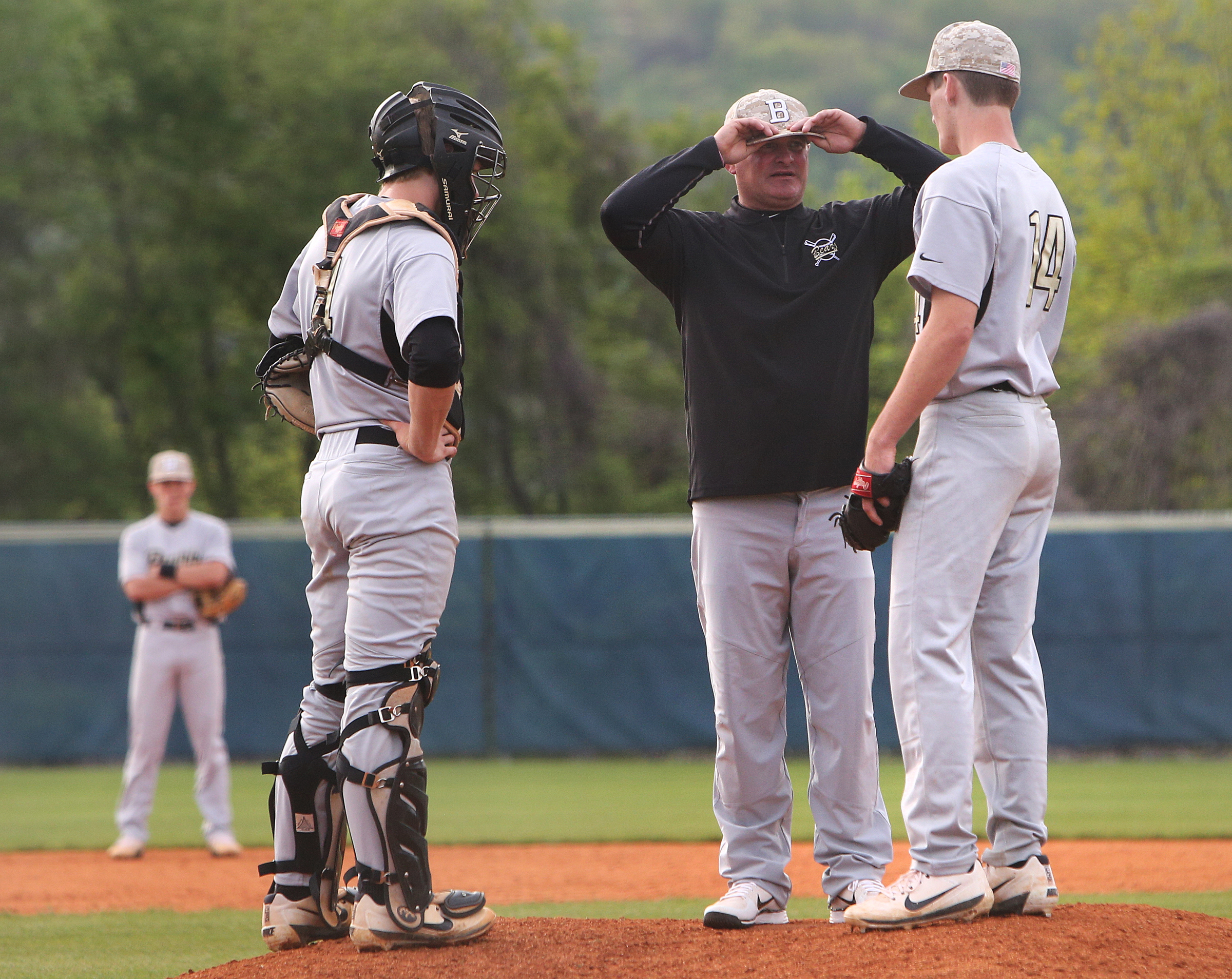 Bradley Central catcher Preston Taylor (4) and pitcher Jake Prock (14) speak with their coach Travis Adams on the mound during the first Soddy-Daisy vs. Bradley Central baseball game at Soddy-Daisy High School Wednesday, April 25, 2018 in Soddy-Daisy, Tenn.