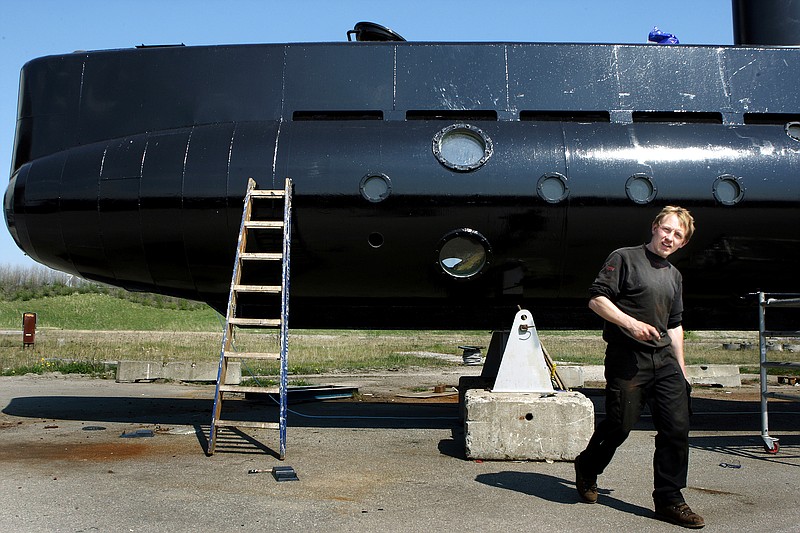 FILE - This April 30, 2008 file photo shows a submarine and its owner Peter Madsen. One of the most talked-about and macabre court cases in recent Danish history is set to conclude Wednesday, April 25, 2018 when the verdict is handed down on whether Peter Madsen tortured and murdered a Swedish journalist during a private submarine trip.  (Niels Hougaard/Ritzau via AP, File)
