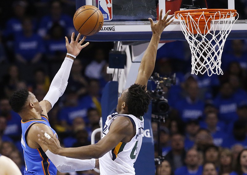 Oklahoma City Thunder guard Russell Westbrook, left, shoots as Utah Jazz guard Donovan Mitchell defends during the second half of Game 5 of an NBA basketball first-round playoff series in Oklahoma City, Wednesday, April 25, 2018. (AP Photo/Sue Ogrocki)