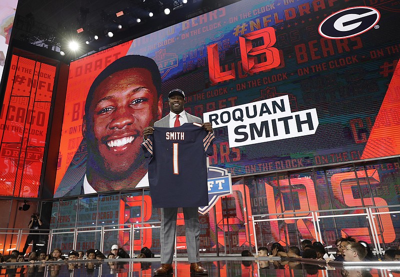 Georgia's Roquan Smith poses with his Chicago Bears jersey after being selected by the team during the first round of the NFL football draft, Thursday, April 26, 2018, in Arlington, Texas. (AP Photo/David J. Phillip)