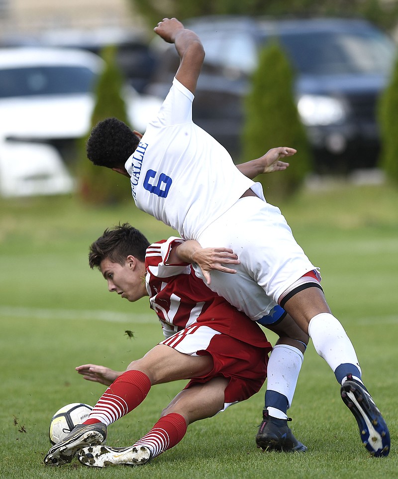 Baylor's Christian Stophel (17) and Stone Roebuck (6) go down after they collide.  The Baylor Red Raiders visited the McCallie Blue Tornado in TSSAA soccer action on April 27, 2018