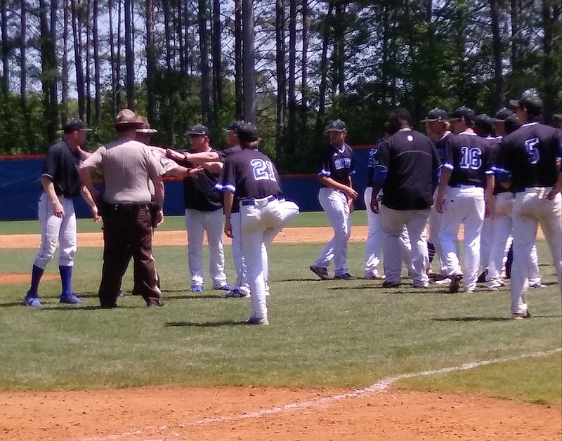 Whitfield County deputies calm LaGrange High School baseball coaches and players after a postgame altercation Saturday at Northwest Whitfield. Northwest coach Todd Middleton said a LaGrange player threw a punch in the handshake line.
