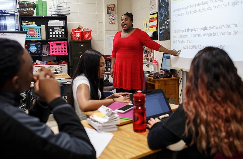 Teacher Ashley Cox points to an electronic lesson accessed by students through Chromebooks during an ACT preparation class for juniors at Howard School on Jan. 31.