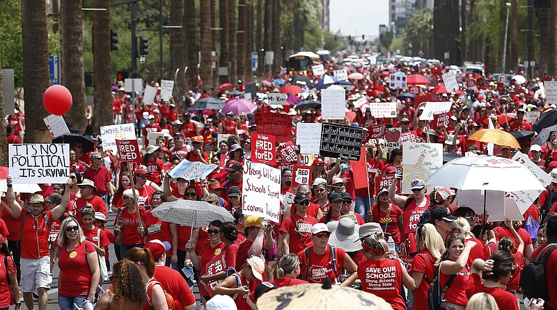 Thousands march to the Arizona Capitol for higher teacher pay and school funding on the first day of a state-wide teacher strike Thursday, April 26, 2018, in Phoenix. (AP Photo/Ross D. Franklin)