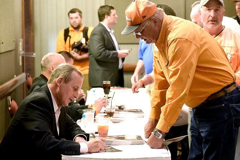 UT mens basketball coach Rick Barnes (left) signs autographs.  The University of Tennessee Big Orange Caravan rolled into town at the Chattanoogan on Thursday May 5, 2016.
