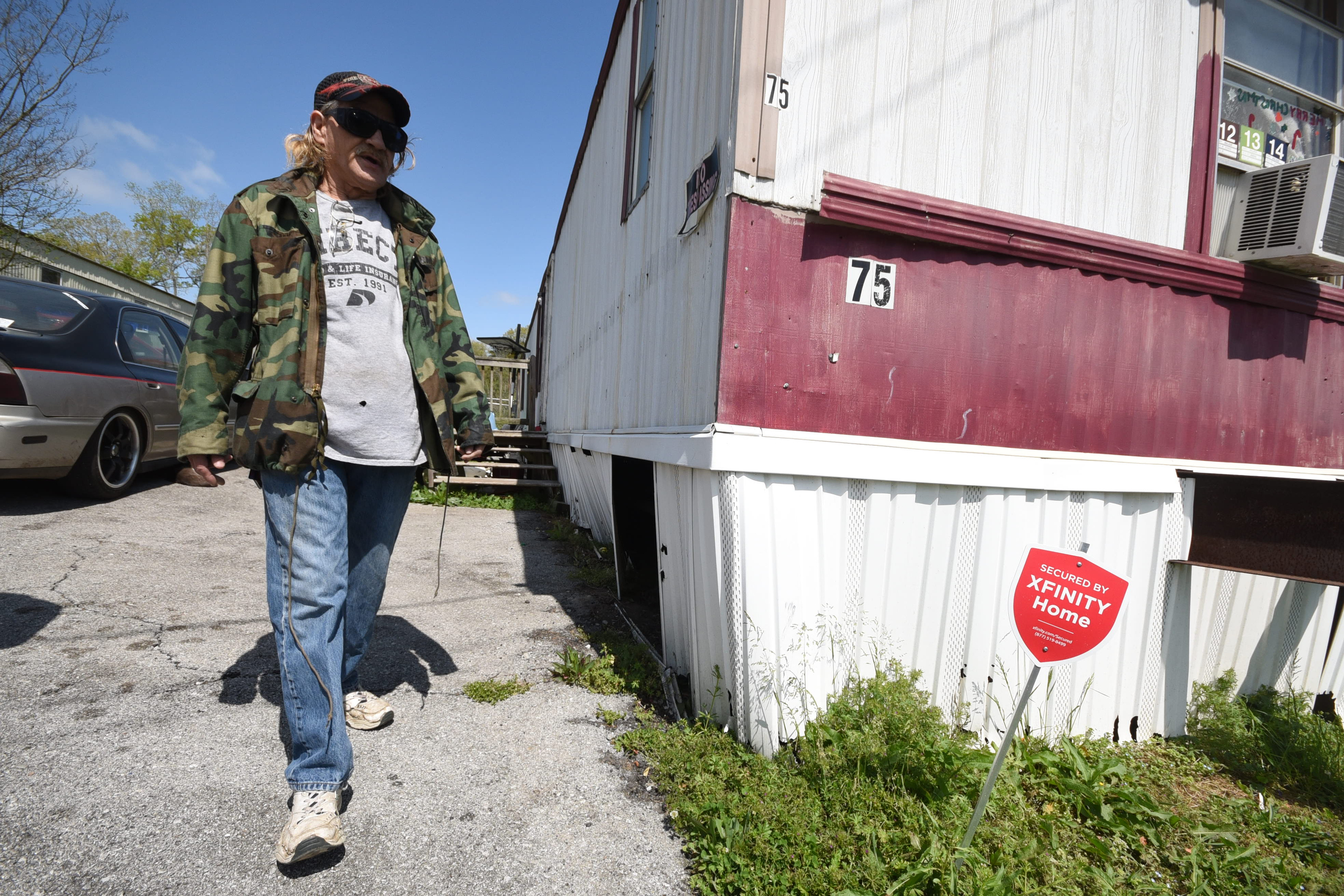 Marshall Wilson walks past a busted water line where the underpinning is pulled away on his trailer at Stoney Pointe Mobile Home Park in Rossville.