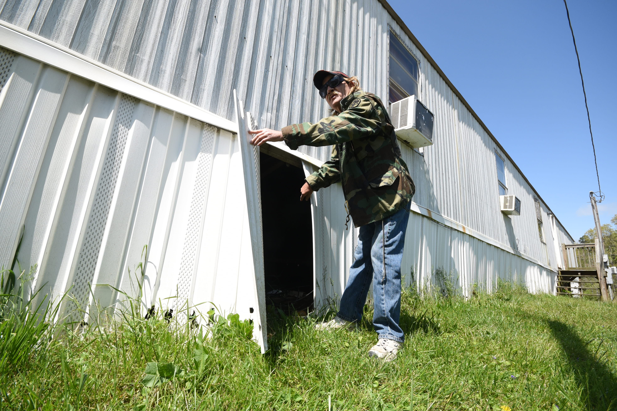 Marshall Wilson talks about meter reading personnel pull away the underpinning on his trailer regularly at Stoney Pointe Mobile Home Park in Rossville.