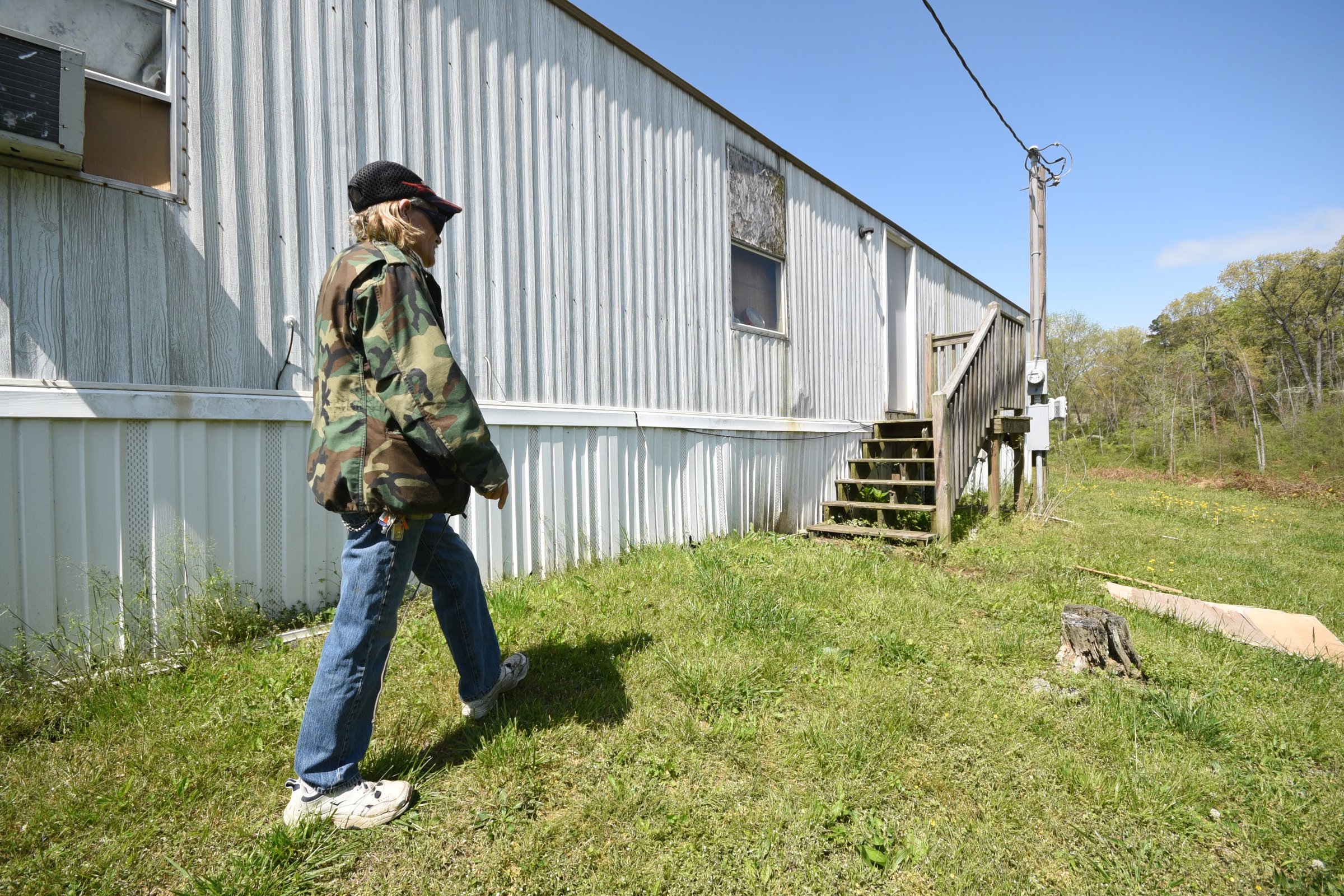 Marshall Wilson walks behind his trailer at Stoney Pointe Mobile Home Park in Rossville.