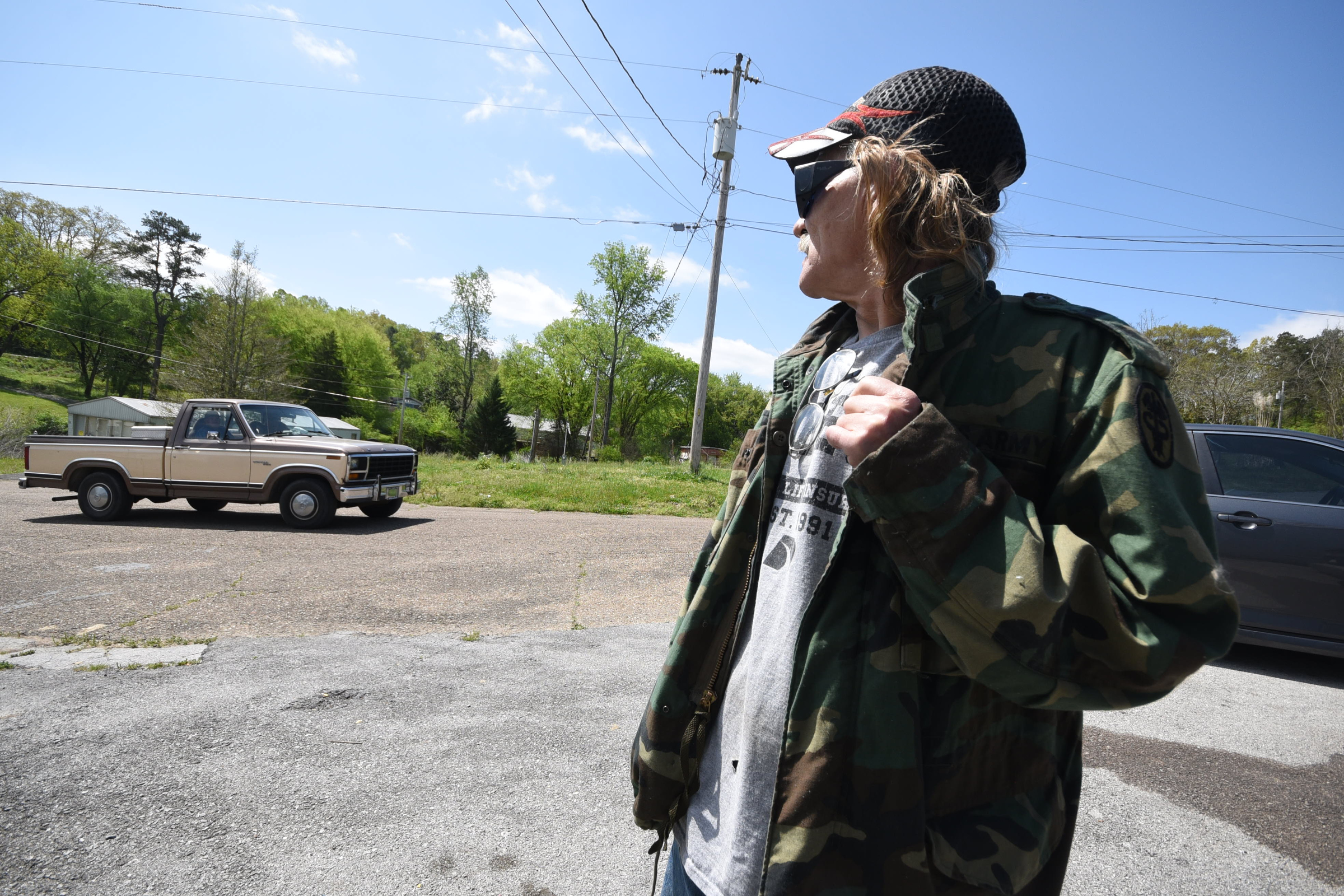 Marshall Wilson looks over his shoulder as a maintenance crew passes his trailer Thursday at Stoney Pointe Mobile Home Park in Rossville.