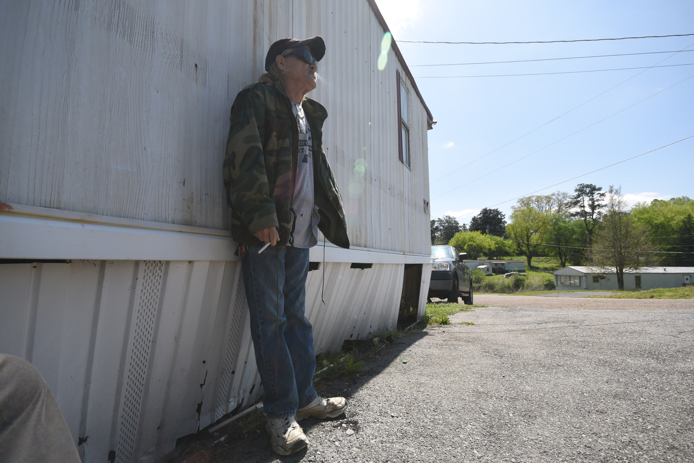 Marshall Wilson enjoys a smoke outside his trailer at Stoney Pointe Mobile Home Park in Rossville.
