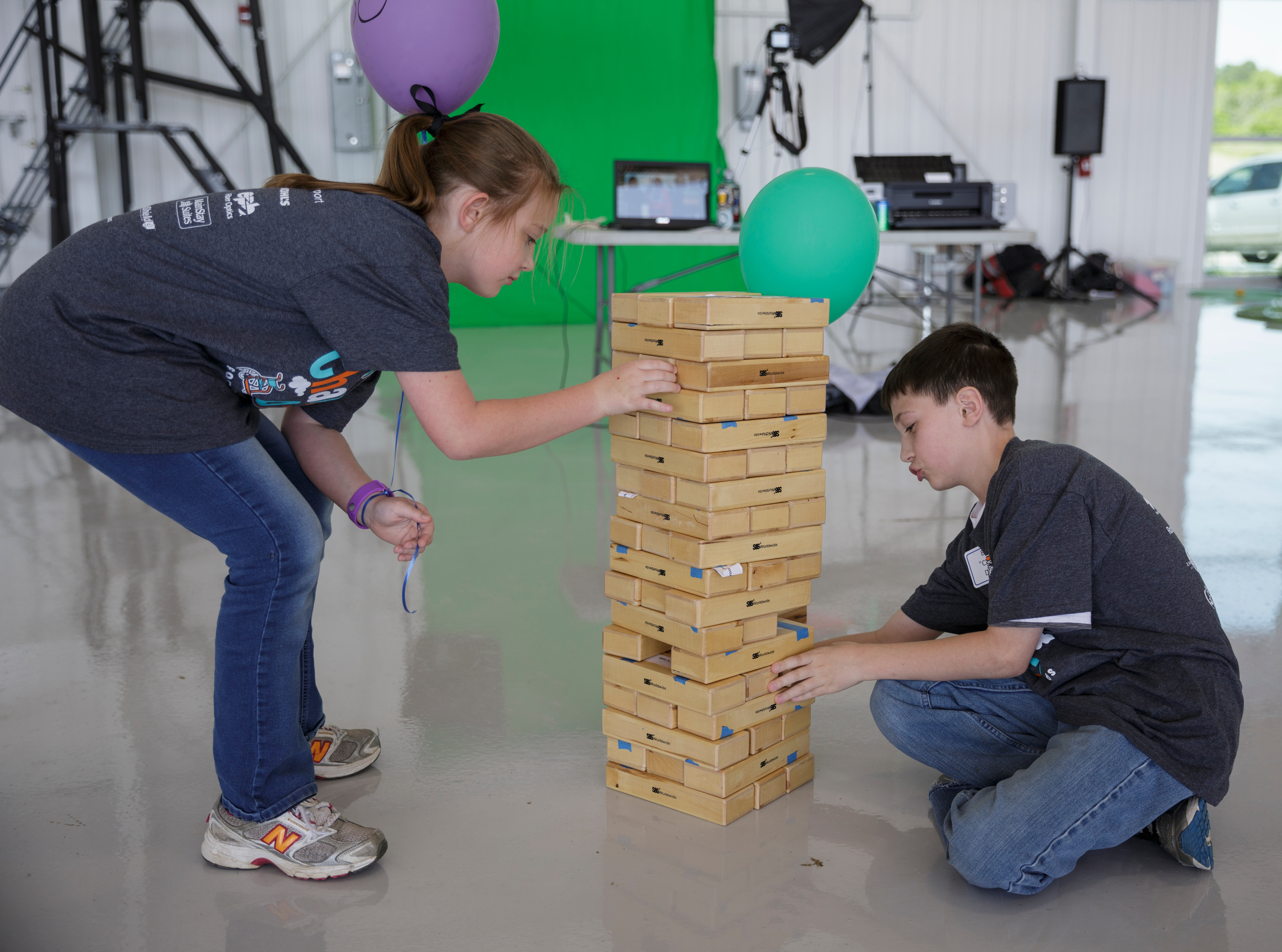 Carlie Dufour, left, and Bryan Dufour play giant Jenga during the Challenge Air Fly Day at the Chattanooga Airport's Wilson Air Center on Saturday, April 28, 2018, in Chattanooga, Tenn. Fly Day offers youth ages 7 to 21 with intellectual or physical disabilities and their families the chance to experience a 30-minute small-aircraft flight and to learn about aviation.