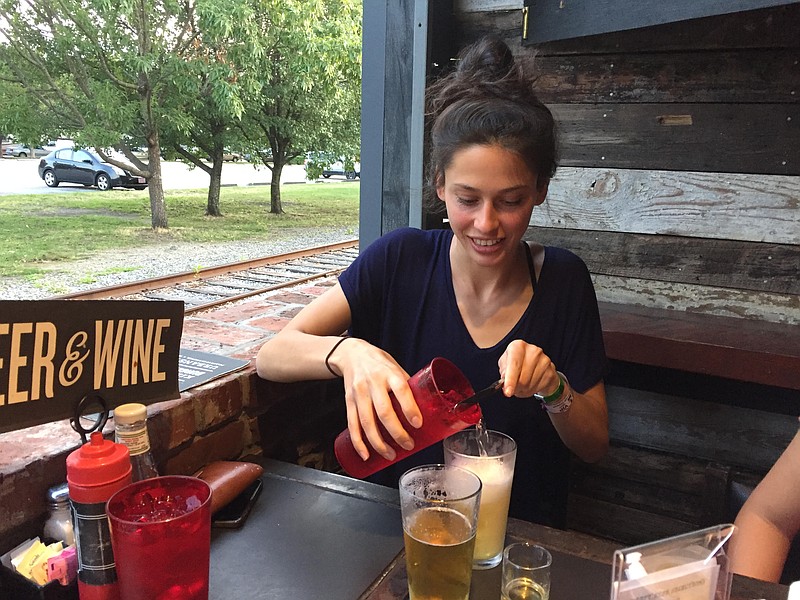 Julie Bage and her family introduce English professional triathlete Hannah Drewitt to burgers at Urban Stack. In return, Drewitt introduced the Bages to a "shandy," a popular English beverage made by mixing beer and lemonade.