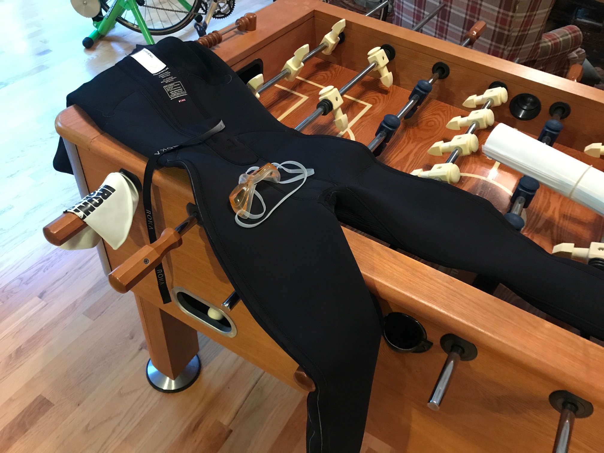 A triathlete drapes her Ironman swim gear over Katie Schumacher's foosball table.