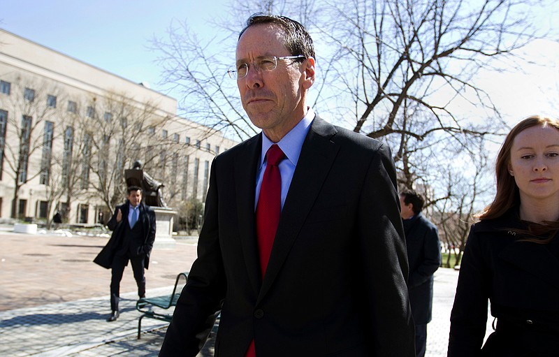 FILE - In this March 22, 2018, file photo, AT&T CEO Randall Stephenson leaves the federal courthouse, in Washington. The U.S. government pleaded its case Monday, April 30, for blocking AT&T from absorbing Time Warner, saying it would hurt consumers as a big antitrust trial crept toward its end and a decision by a federal judge. (AP Photo/Jose Luis Magana, File)