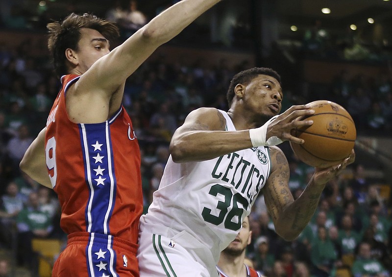 Boston Celtics guard Marcus Smart (36) makes a move with the ball against Philadelphia 76ers forward Dario Saric (9) in the second half of Game 1 of an NBA basketball second-round playoff series, Monday, April 30, 2018, in Boston. The Celtics won 117-101. (AP Photo/Elise Amendola)