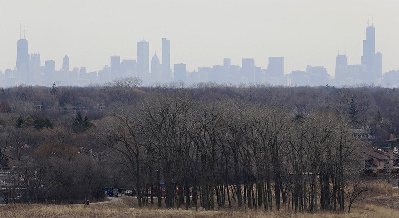 FILE - In this March 19, 2015, file photo, a thick haze of smog looms over the skyline of Chicago. A new study in the Proceedings of the National Academy of Sciences finds that America’s nitrogen oxides levels, a key ingredient in smog, aren’t falling as fast as they used to and may be leveling off. The Monday, April 30, 2018, study means that when tighter new air quality standards go into effect later this fall, more cities may find themselves on federal's dirty air list. (AP Photo/Nam Y. Huh, File)