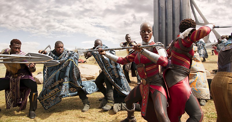 Ayo, foreground, played by Florence Kasumba, leads an action scene in "Black Panther 3D."
