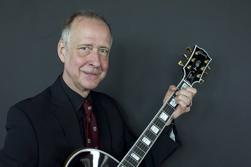 FILE - In this June 17, 2016, file photo, Henry Juszkiewicz, CEO of Gibson Brands, poses for a portrait with a Gibson Custom L-5 guitar during the official opening of the European hub of Gibson Brands at the A'dam Tower in Amsterdam, Netherlands. The maker of the Gibson guitar, omnipresent for decades on the American rock 'n' roll stage, is filing for bankruptcy protection after wrestling for years with debt. (AP Photo/Peter Dejong, File)