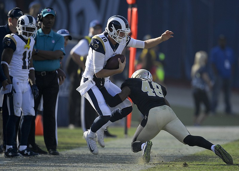 Los Angeles Rams quarterback Jared Goff jumps out of the way of New Orleans Saints free safety Vonn Bell during the first half of an NFL football game Sunday, Nov. 26, 2017, in Los Angeles. (AP Photo/Mark J. Terrill)