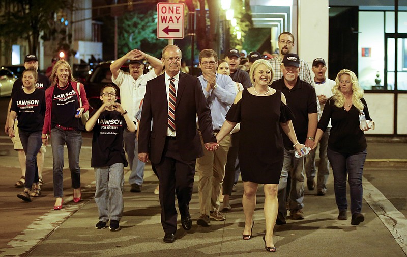 Steve Lawson, left, and his wife, Connie, lead supporters on a victory march toward the Bradley County Courthouse after he defeated incumbent Sheriff Eric Watson on Tuesday, May 1, 2018, in Cleveland, Tenn.