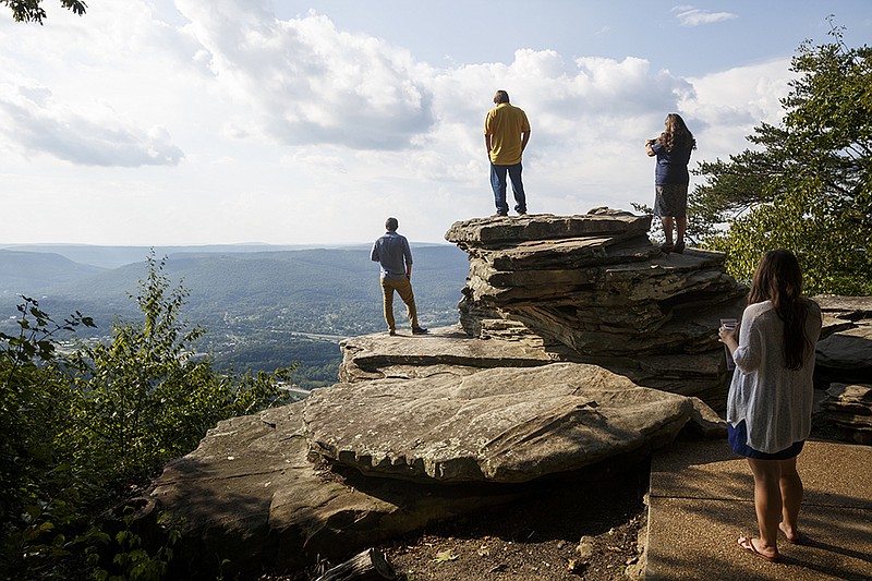 Brandon, Tim and Marshana Sharp, from left, look out over Lookout Valley from an observation point at Point Park atop Lookout Mountain.