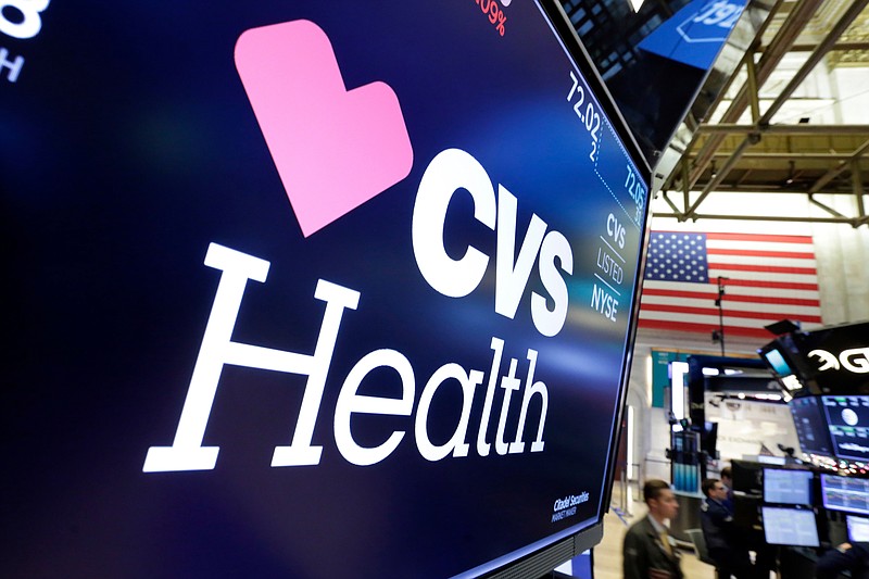 FILE- In this Dec. 4, 2017, file photo, the CVS Health logo appears above a trading post on the floor of the New York Stock Exchange. CVS Health reports earnings Wednesday, May 2, 2018. (AP Photo/Richard Drew, File)