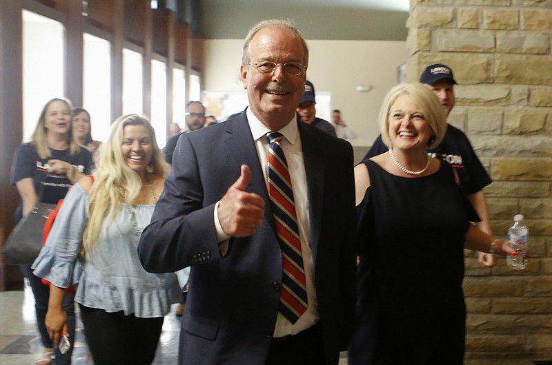 Steve Lawson gives a thumbs up for the camera as he and wife Connie lead supporters on a victory march from the Museum Center at 5ive Points toward the Bradley County Courthouse after he defeated incumbent Sheriff Eric Watson on Tuesday, May 1, 2018 in Cleveland, Tenn.