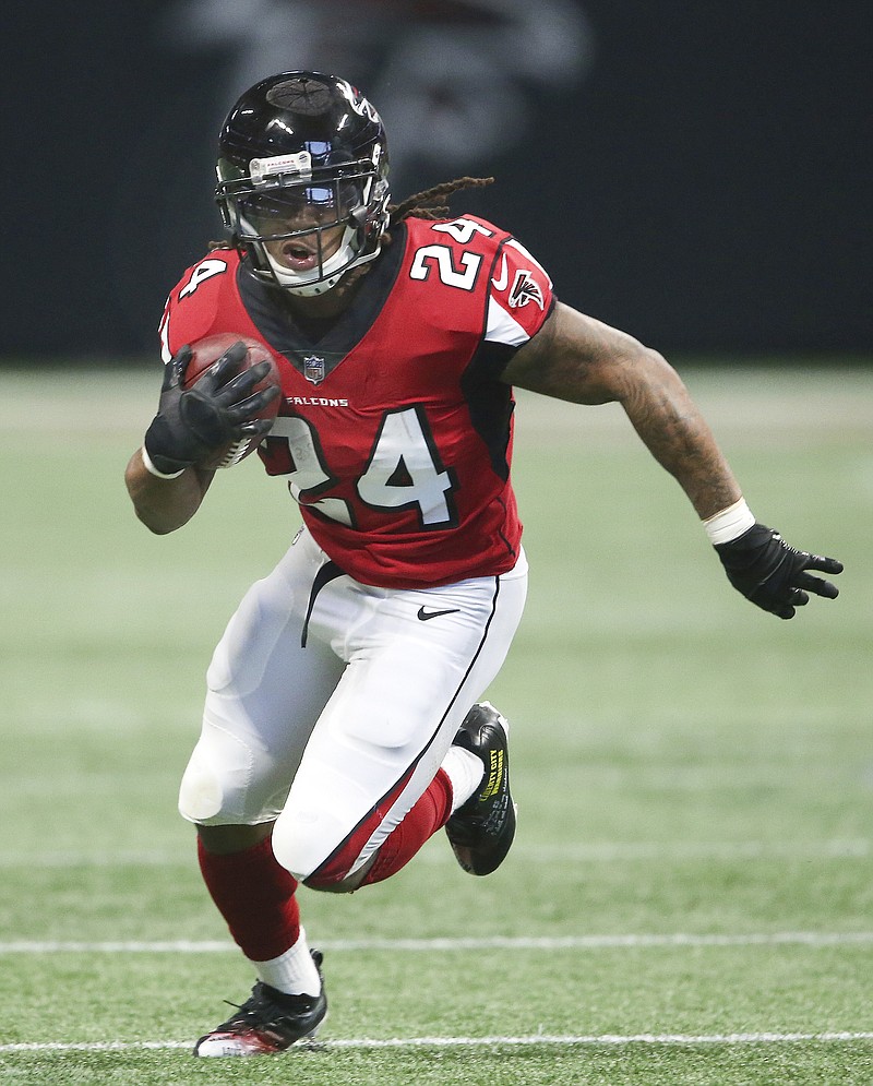 FILE - In this Sunday, Dec. 3, 2017, file photo Atlanta Falcons running back Devonta Freeman (24) is shown during the first half of an NFL football game against the Minnesota Vikings in Atlanta. After being slowed late last season by a sprained right knee and missing two games with his second of two 2017 concussions, Freeman said Wednesday, May 2, 2018, he's feeling strong and expects to be ready for training camp this summer. (AP Photo/John Bazemore, File)