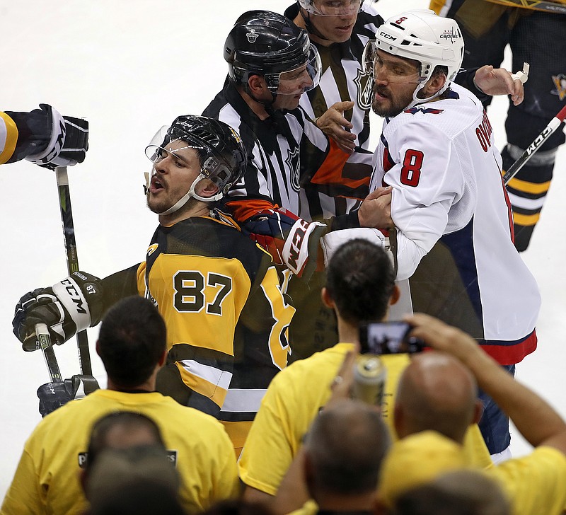Washington Capitals' Alex Ovechkin (8) grabs Pittsburgh Penguins' Sidney Crosby (87) during the second period in Game 3 of an NHL second-round hockey playoff series in Pittsburgh, Tuesday, May 1, 2018. (AP Photo/Gene J. Puskar)