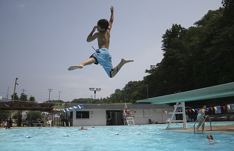 Bryce Verbal, 9, jumps off the diving board at Red Bank PooL.