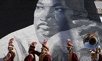 Members of the Howard School marching band walk past a mural of Martin Luther King Jr. while lining up for a memorial parade and march along M.L. King Boulevard.