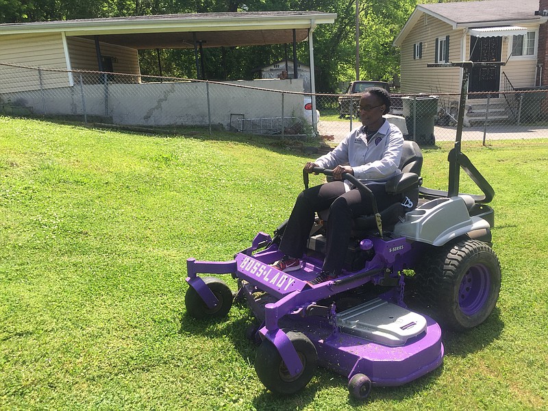 Shawna Kyle mows yard in Eastdale on Thursday, May 3, 2018, with her "Boss Lady" mower she acquired for her lawn maintenance business named after her late son, JTH Enterprise.