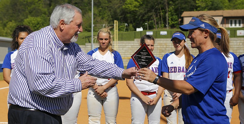 Umpiring assigner Larry Bateman, left, presents the Terry Cordell Memorial Softball Sportsmanship award to Red Bank coach Mandi Munn before the Lionettes' home game Monday against Tyner.